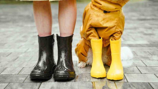 woman and dog in rain boots