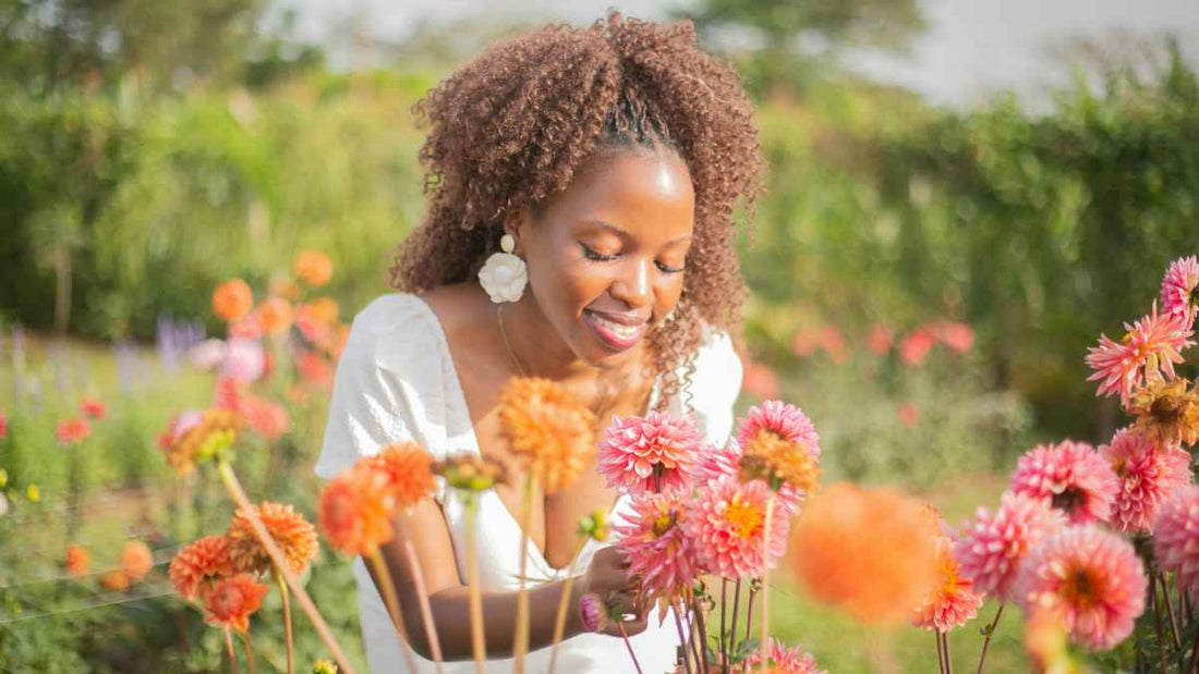 woman admiring orange flowers
