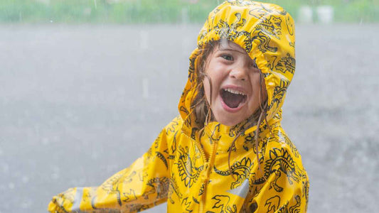 kid laughing in rain