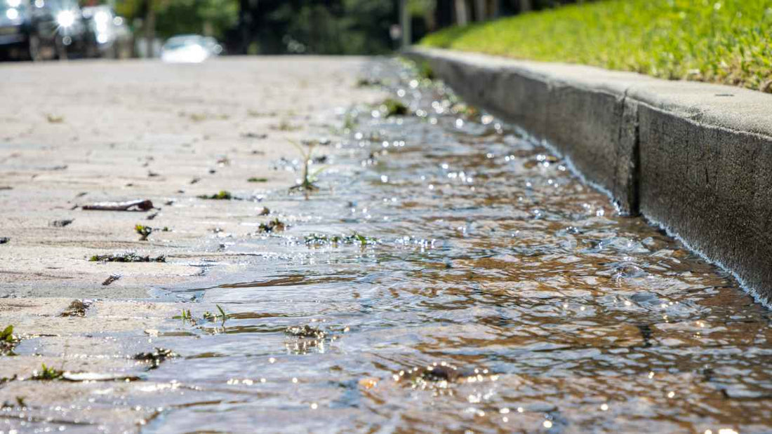 rain running down a sidewalk