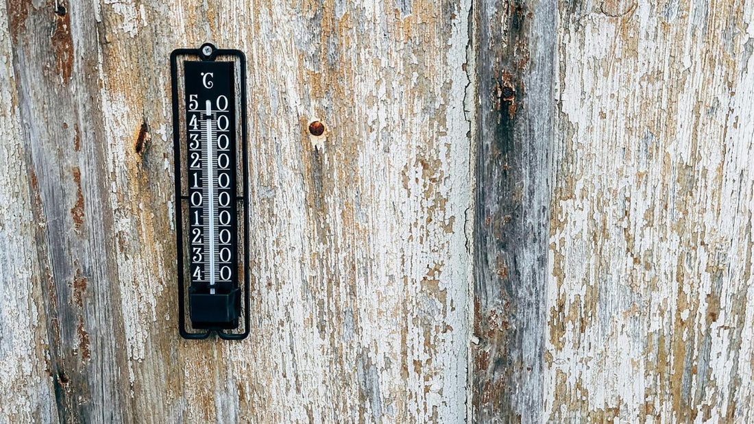 Outdoor thermometer on barn wall