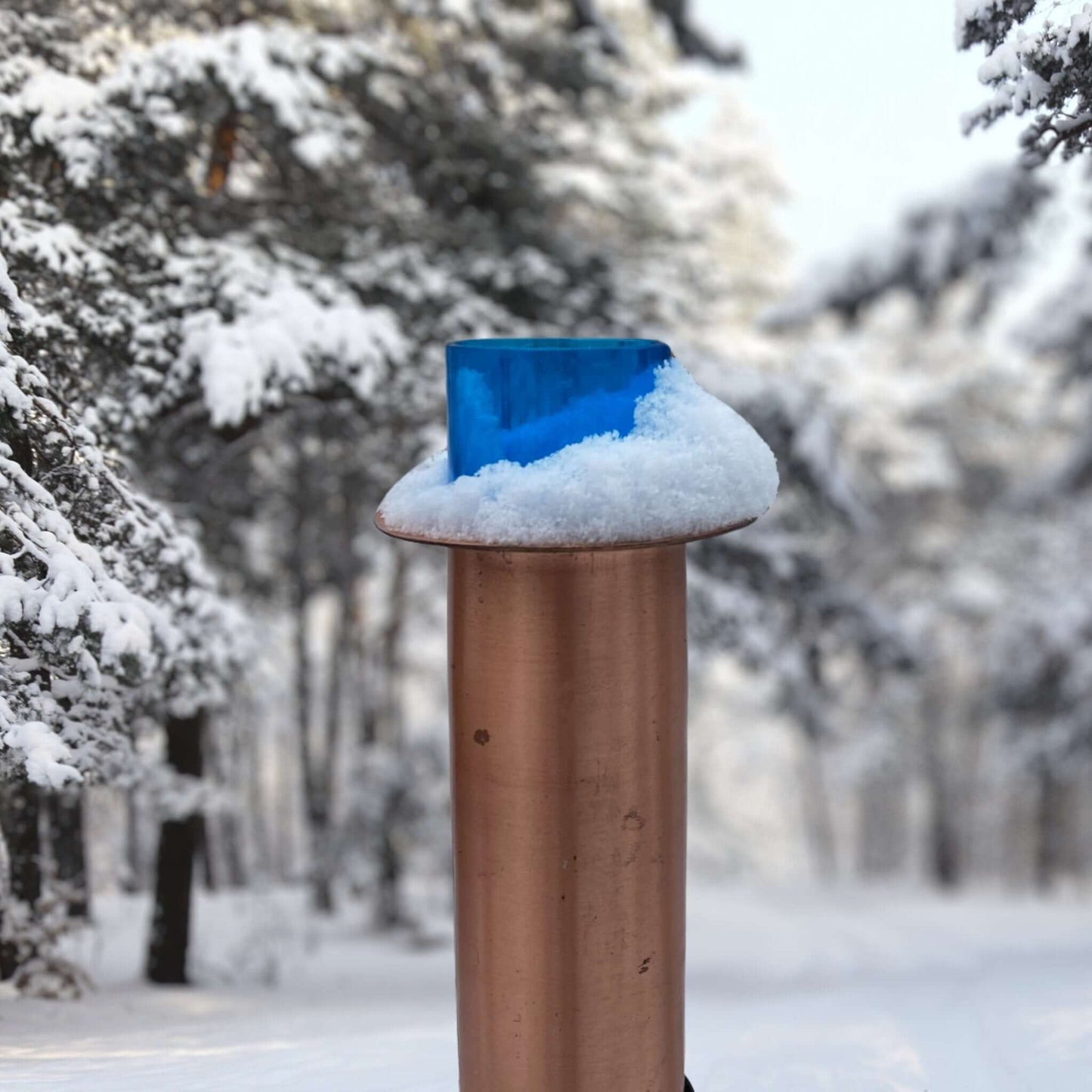 Railing Mount Copper Rain Gauge Covered In Snow